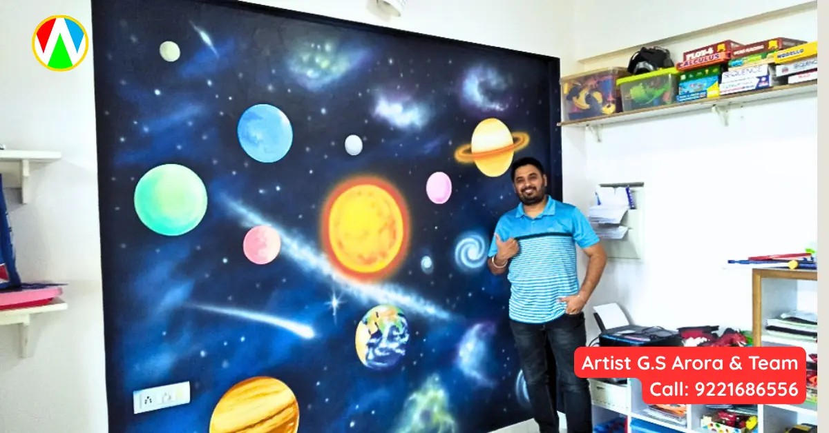 Artist G.S. Arora posing with finished Space theme wall painting